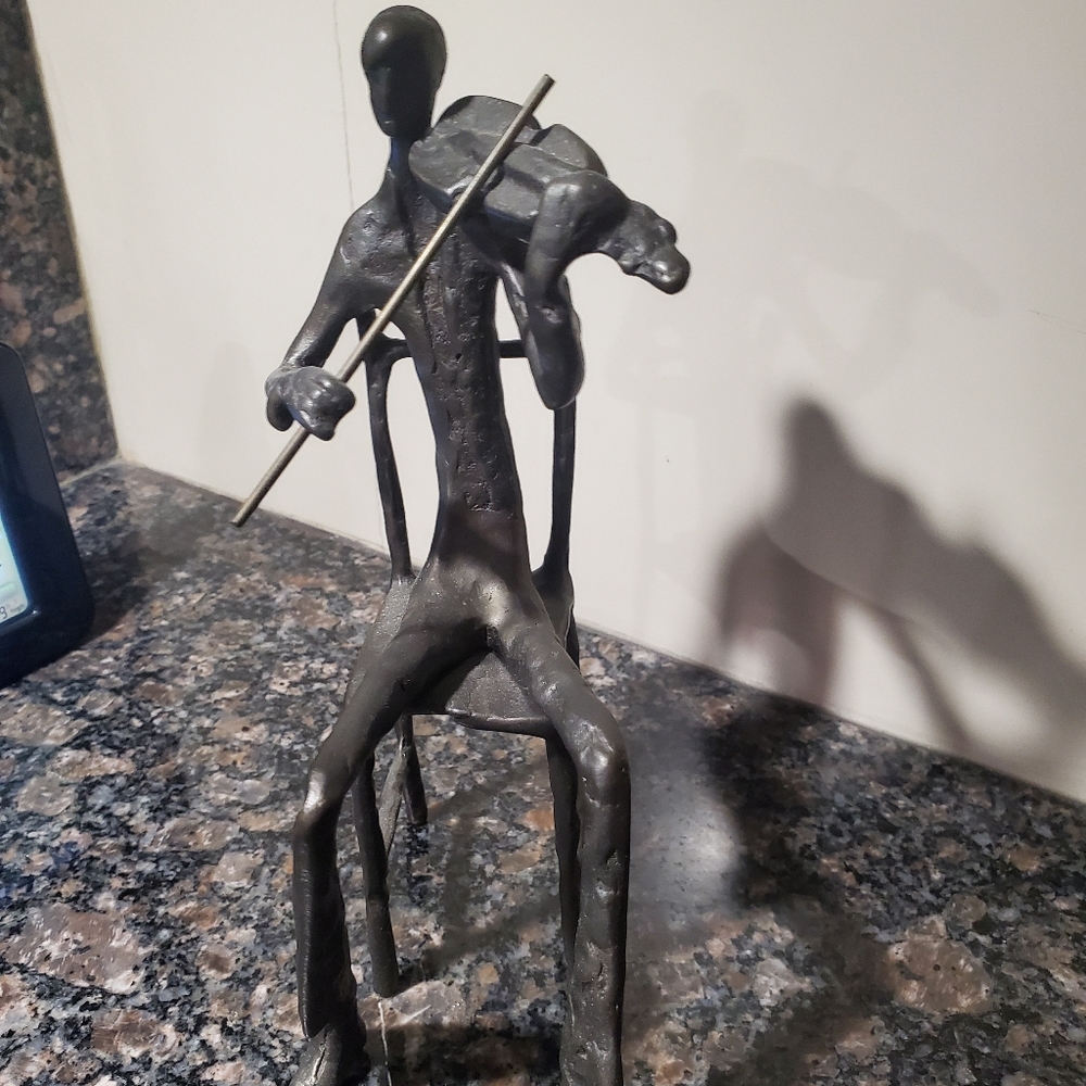 sculpture of violinist ...feels and looks like bronze... but I'm not sur…
